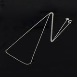 silver fine cable chain with spring ring clasp on black background. 