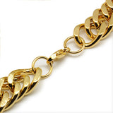 zoomed in sections of golden large Cuban link chain necklace with lobster claw clasp on white background. 