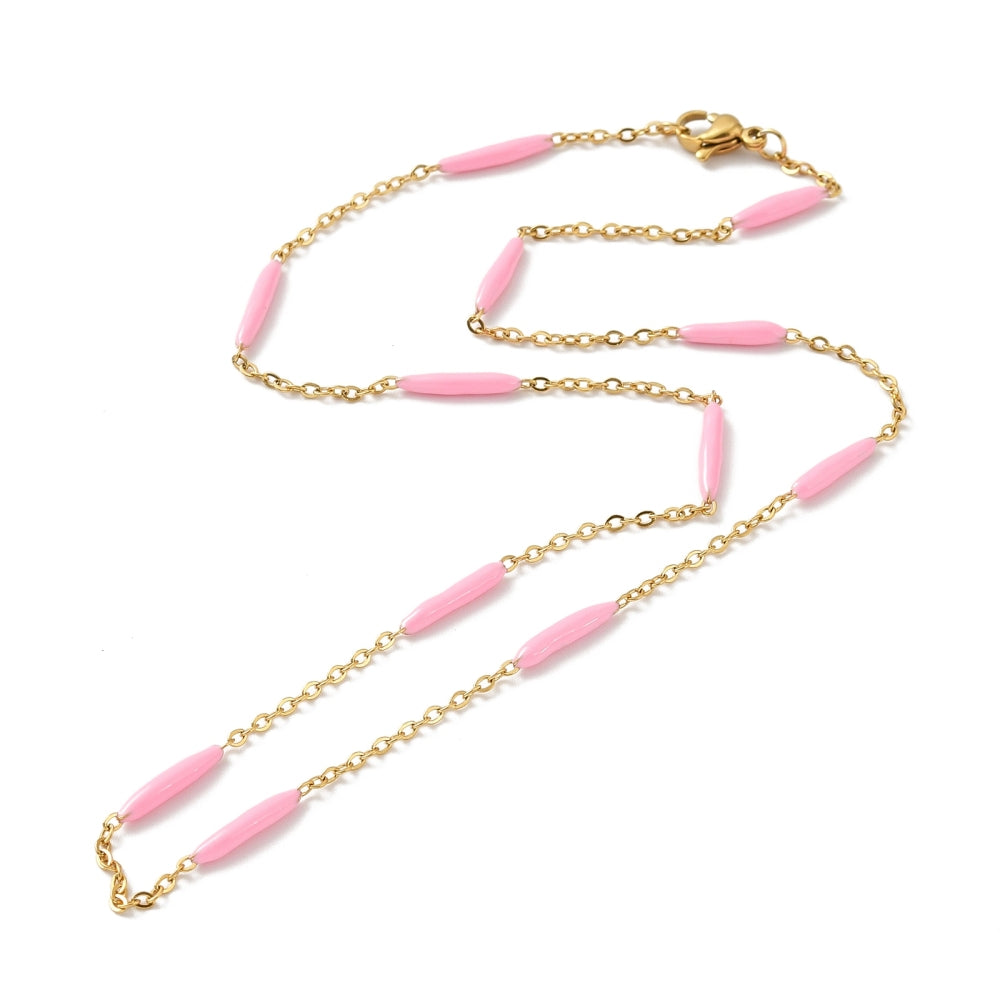 golden curb chain and pink enamel bar link necklace with lobster claw clasp on white background. 