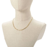 golden medium link paperclip chain necklace on burlap neck form with white background. 
