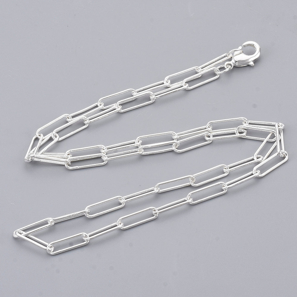 silver medium round oval paperclip chain necklace with lobster claw clasp on light gray background. 