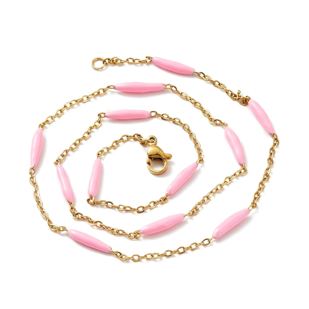 golden curb chain and pink enamel bar link necklace with lobster claw clasp on white background. 