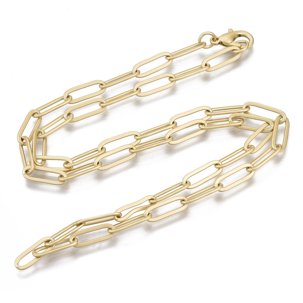 matte golden large paperclip link necklace with lobster claw clasp on white background. 
