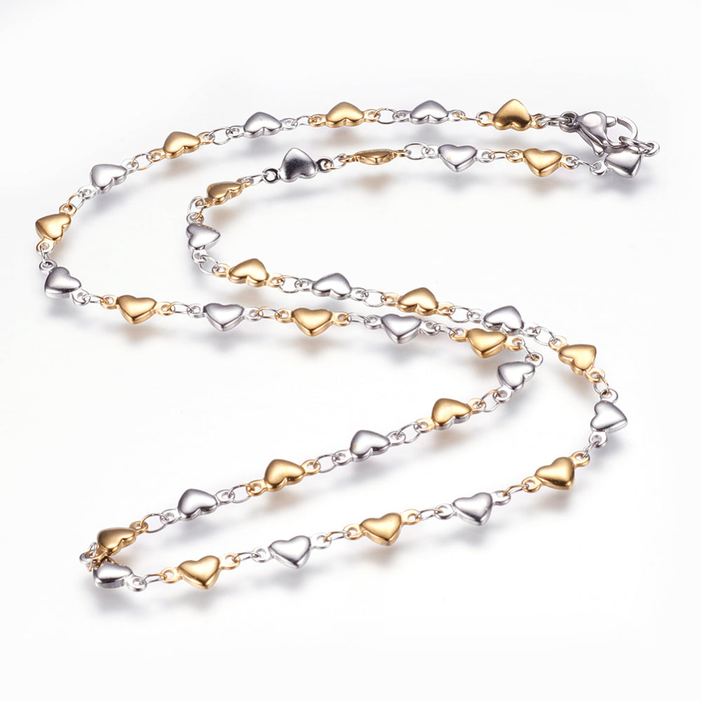 two-tone alternating stainless steel and golden flat heart link necklace with lobster claw clasp on white background. 