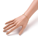 golden satellite tube chain bracelet with lobster claw clasp and extender on mannequin arm against white background. 