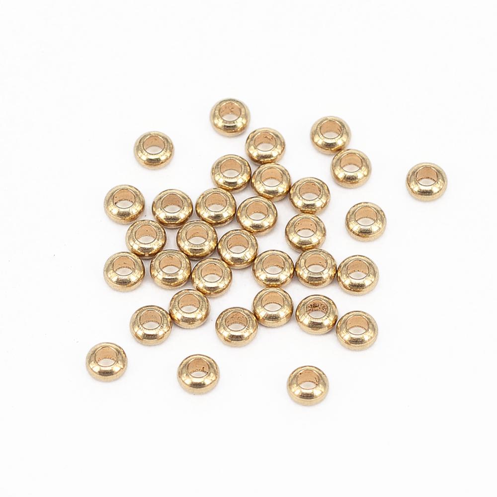 golden smooth rondelle spacer beads over white background. 