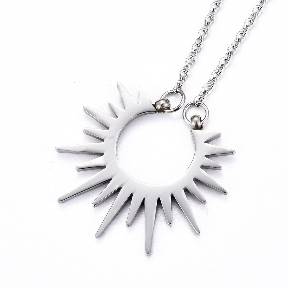 stainless steel sun pendant necklace on cable chain on white background. 