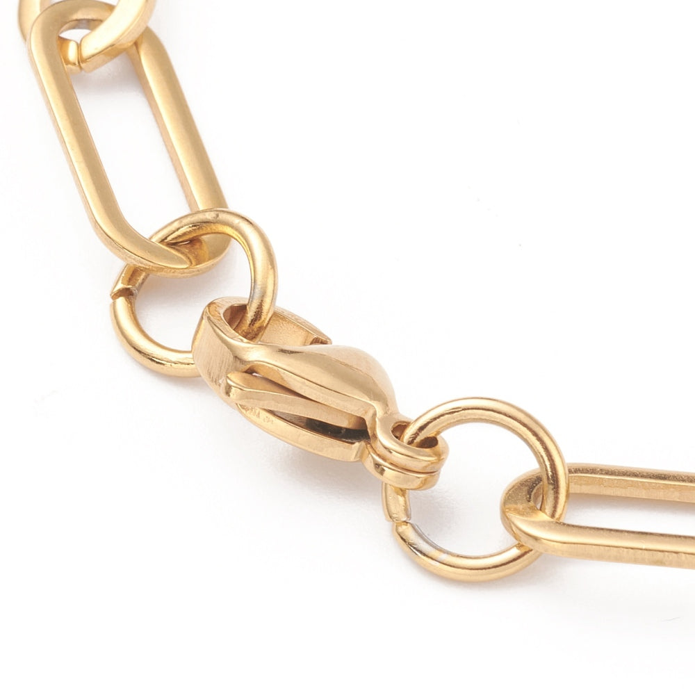 zoomed in golden lobster claw clasp on a white background. 