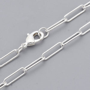 silver medium round oval paperclip chain necklace with lobster claw clasp on light gray background. 