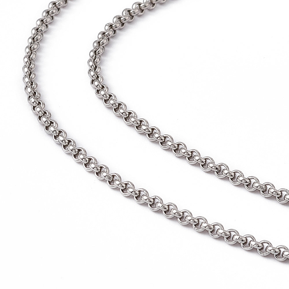 zoomed in sections of stainless steel Rolo chain on white background. 