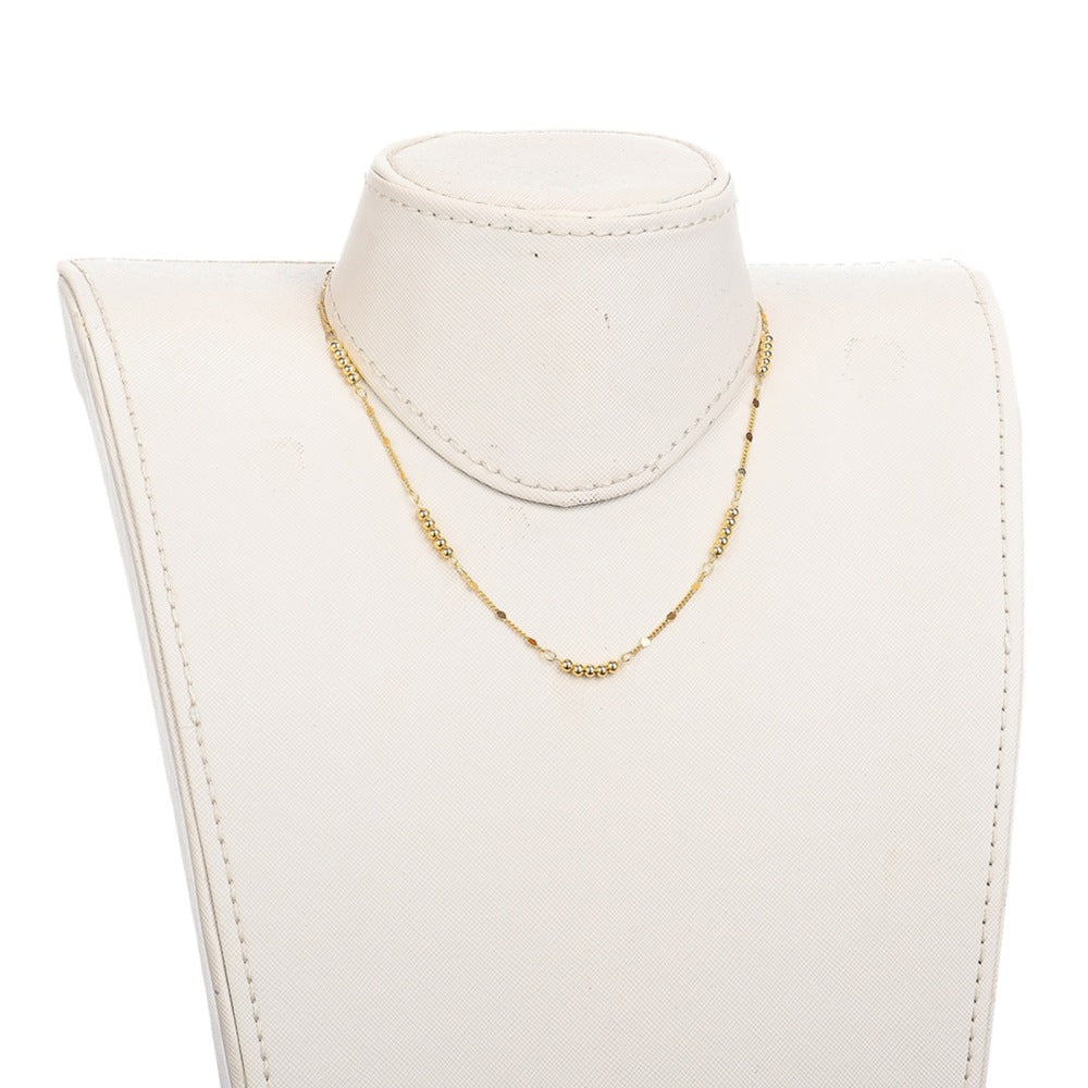 golden 5 round bead bar necklace on white neck form with white background. 