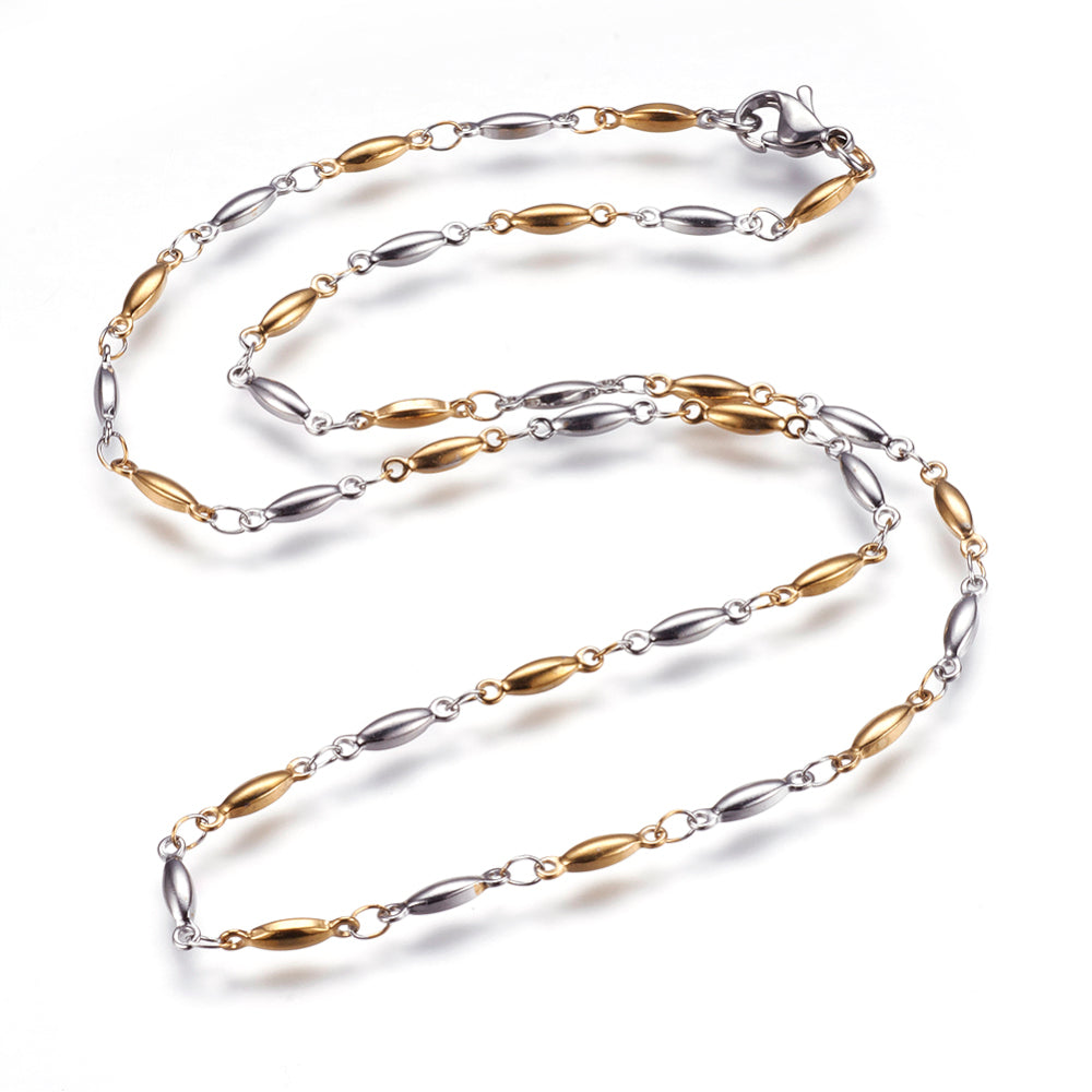 two-tone alternating golden and stainless steel horse eye link necklace with lobster claw clasp on white background. 