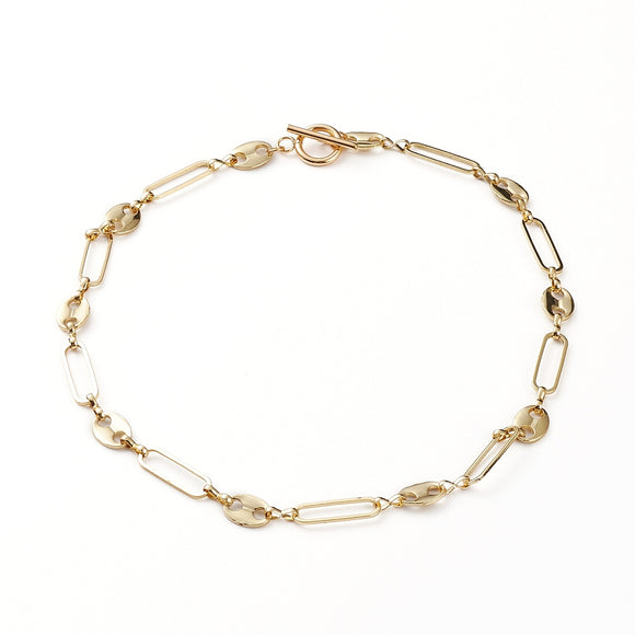 golden alternating paperclip link and coffee bean link chain necklace with toggle clasp on white background. 