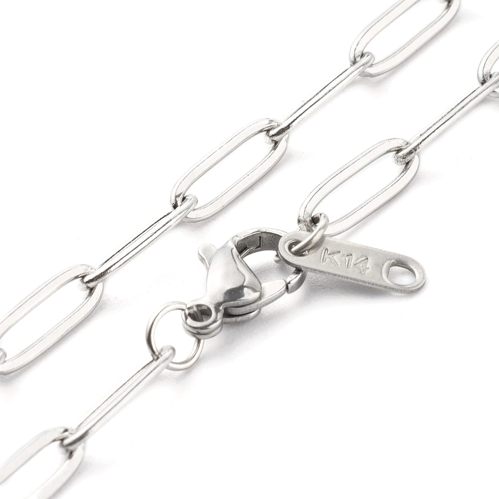 zoomed in sections of silver tone medium link paperclip chain necklace with lobster claw clasp on white background. 