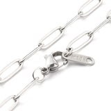 zoomed in sections of stainless steel medium link paperclip chain necklace with lobster claw clasp on white background. 
