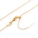 zoomed in on gold plated brass, adjustable box chain with lobster claw clasp on a white background.