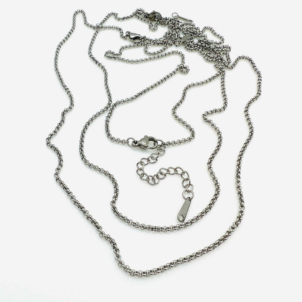 3 stainless steel Rolo chains with lobster claw clasp and extender chain on white background. 