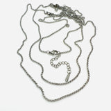 3 stainless steel Rolo chains with lobster claw clasp and extender chain on white background. 