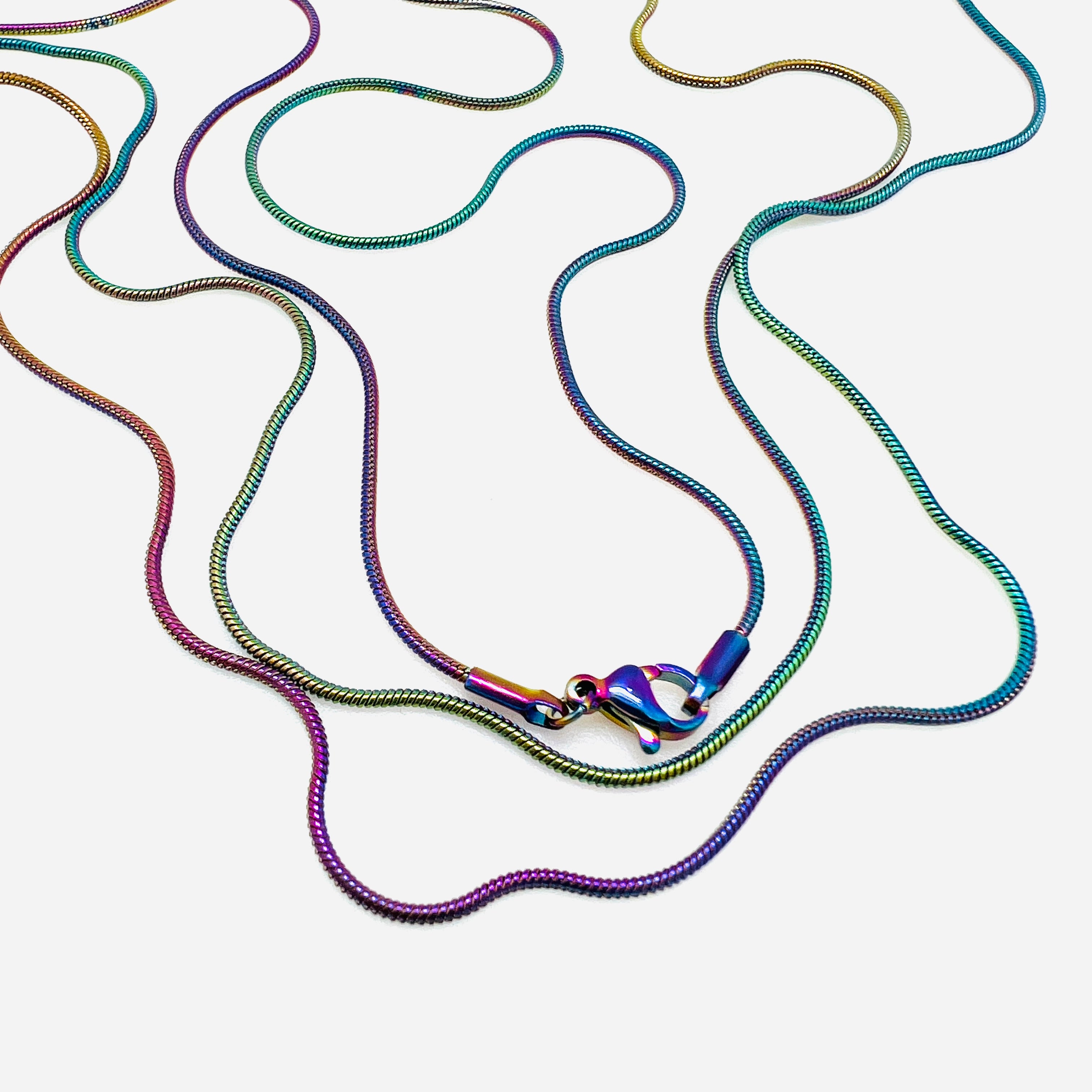 rainbow ion plated snake chain with lobster claw clasp on white background. 