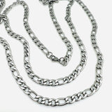 stainless steel Figaro chain necklace with lobster claw clasp on a white background. 