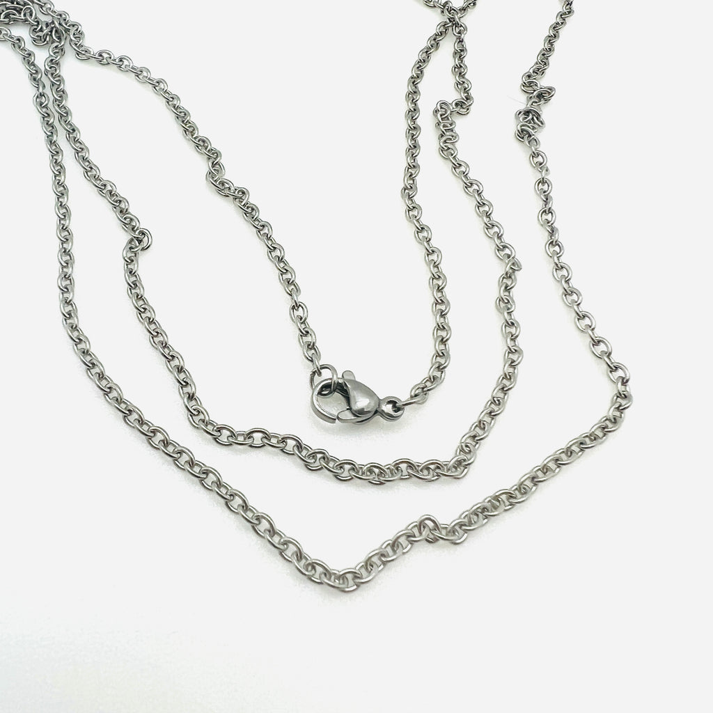 silver tone cable chain necklace with lobster claw clasp over white background. 