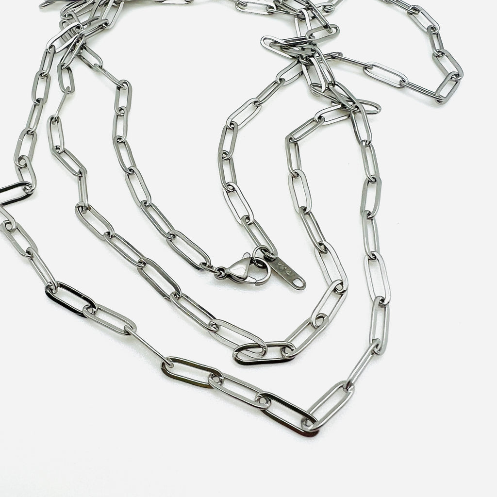 silver tone medium link paperclip chain necklaces with lobster claw clasp on white background. 