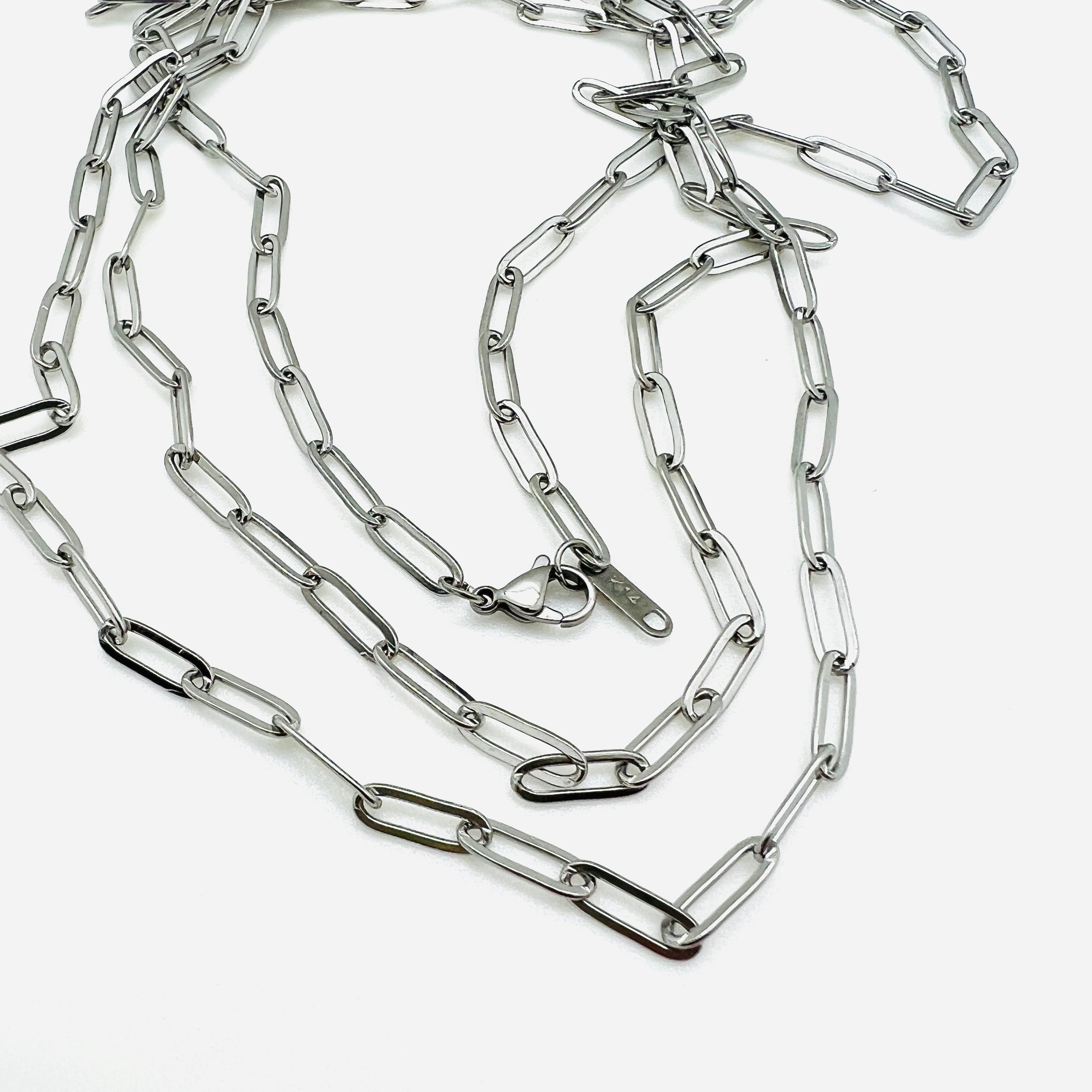 silver tone medium link paperclip chain necklaces with lobster claw clasp on white background. 
