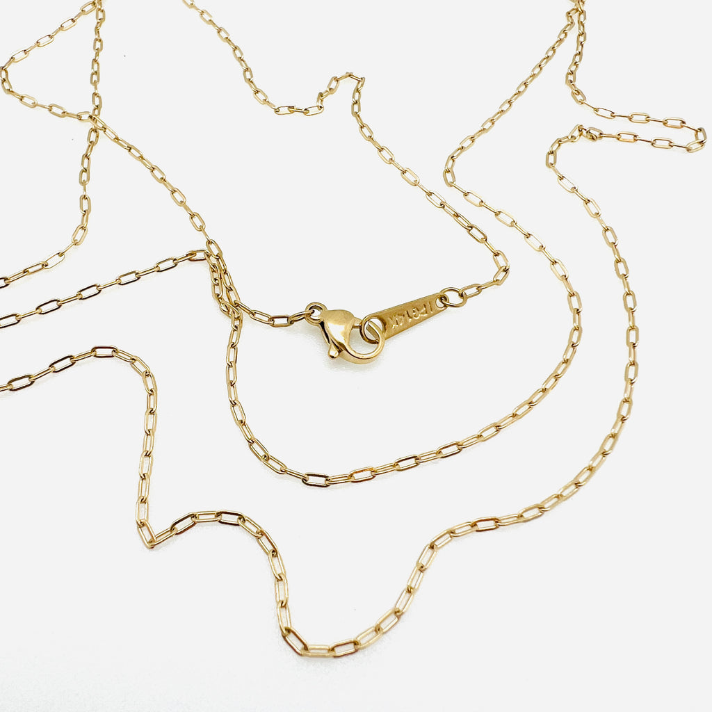 golden tiny paperclip necklace with lobster claw clasp on white background.