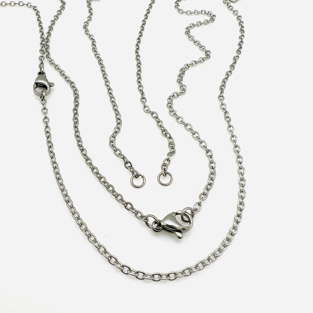 stainless steel cable chain necklace separated in the center with two jump rings ready to attach your favorite connector and a lobster claw clasp against a white background. 
