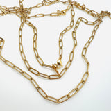 golden medium link paperclip chain necklace with lobster claw clasp and "K14" marked tab on white background. 