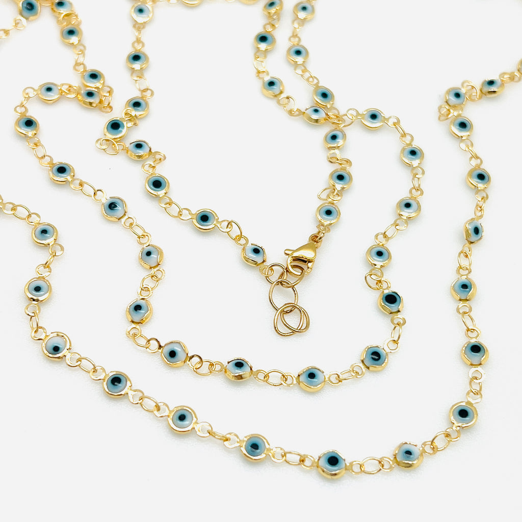 golden white and pale blue Evil Eye link chain necklace with lobster claw clasp over white background. 