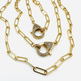 2 golden paperclip chain necklaces with focal clear stone pave lobster claw clasp on white background. 
