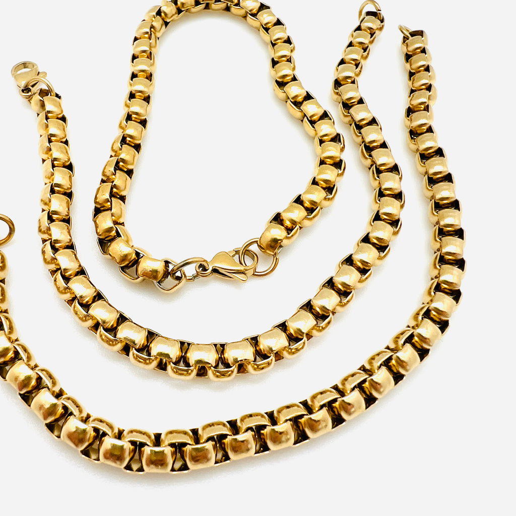 golden Venetian chain bracelet with lobster claw clasp on white background. 