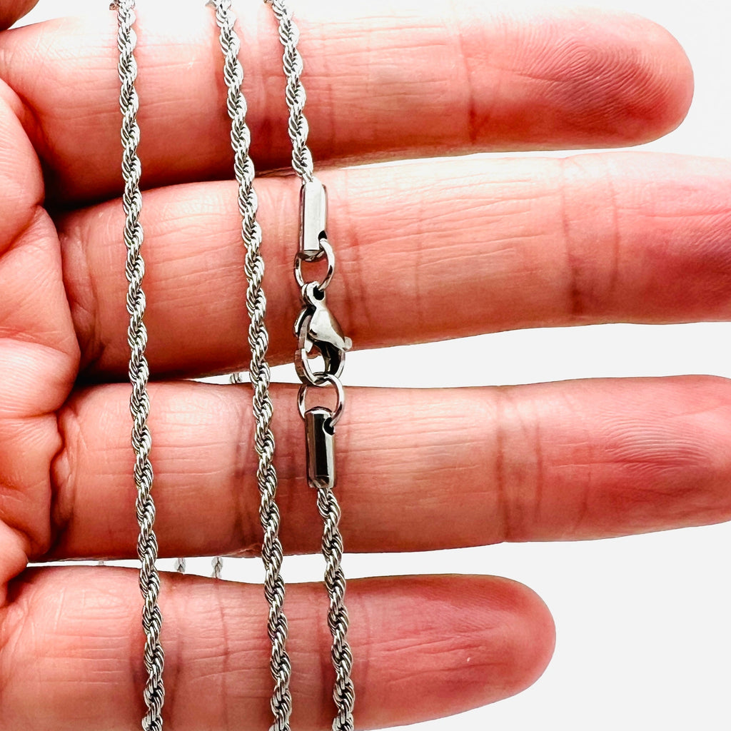 stainless steel rope chain with lobster claw clasp on a hand on white background. 