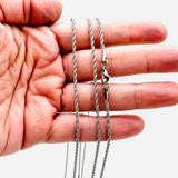 stainless steel rope chain with lobster claw clasp on a hand on white background. 