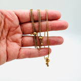 10 inch adjustable, golden plated, stainless steel slider bracelet with slider stopper beads shown on a hand.