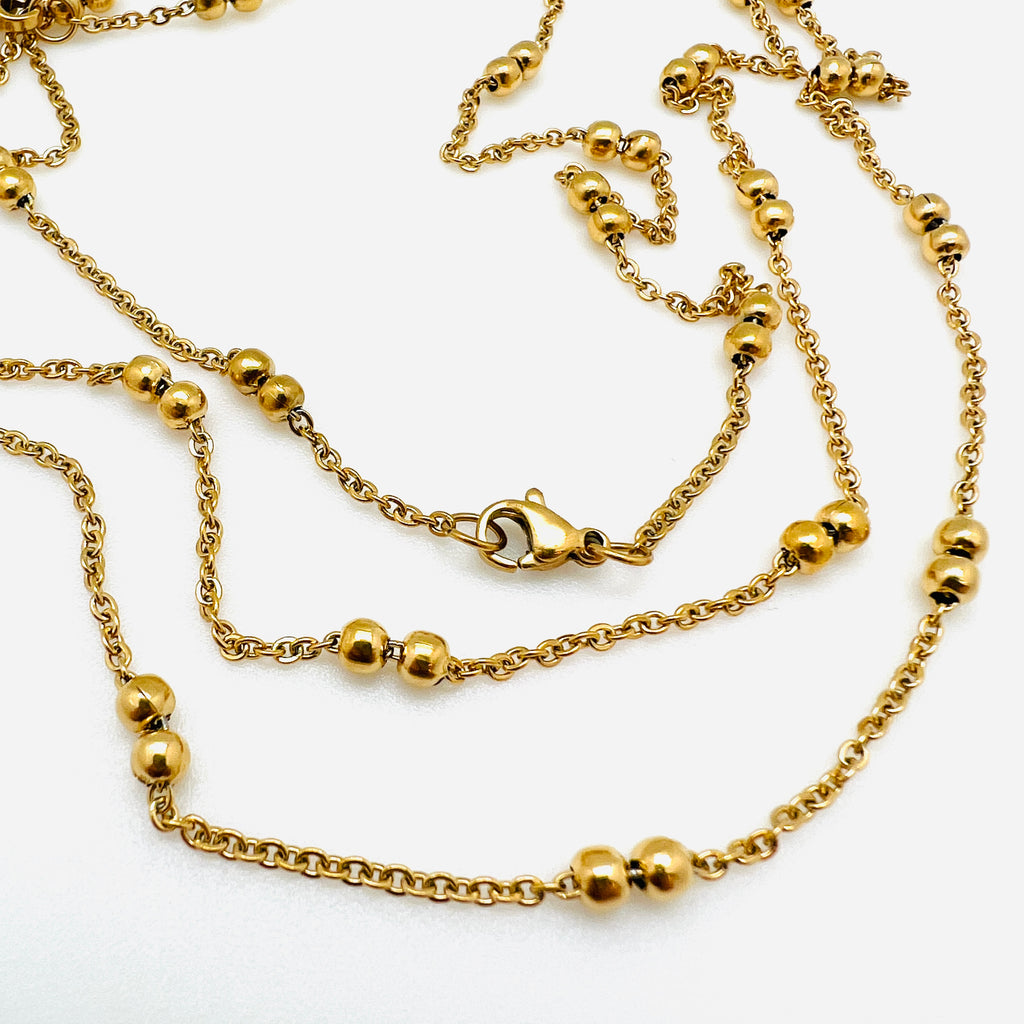 golden cable link double satellite chain necklace with lobster claw clasp on a white background. 