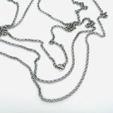 stainless steel medium Rolo chain necklace with lobster claw clasp on white background. 