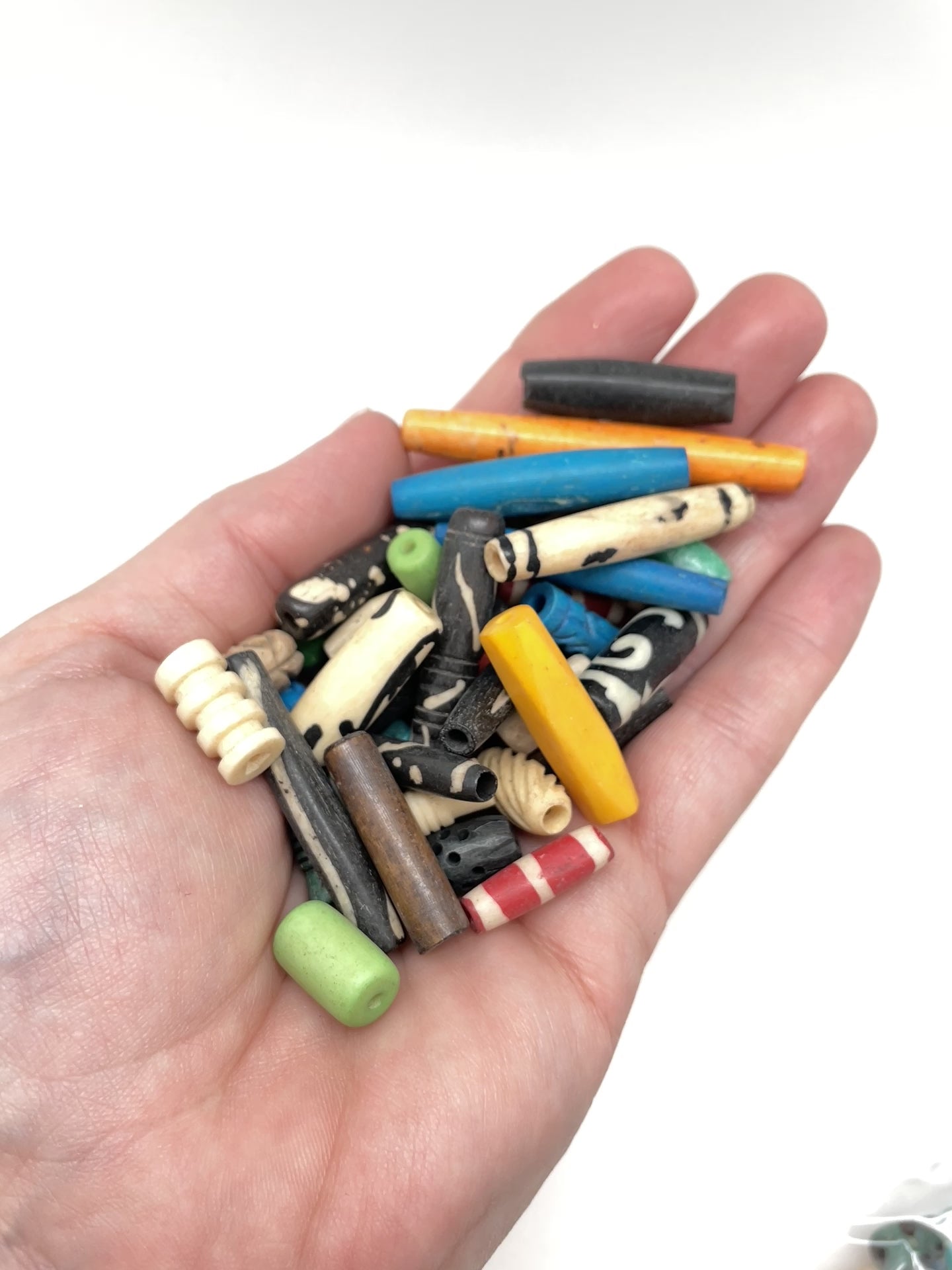 Video of hand moving the bone bead mix around 