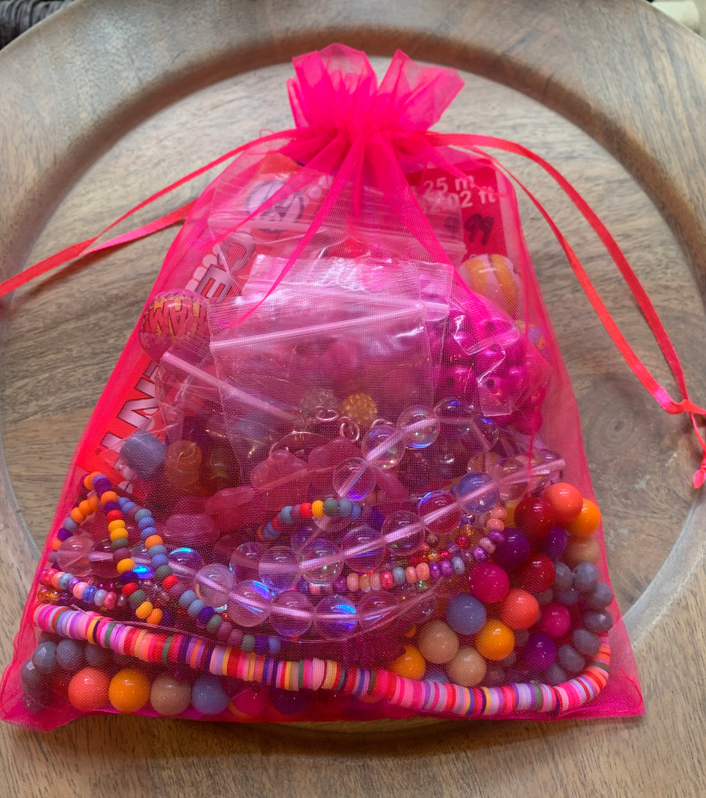 Bead kit full of jewelry making supplies perfect to make beaded bracelets. Kit includes glass beads, seed beads, heishi beads, crystal beads, and charms