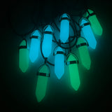 blue and green glow in the dark pendants on a black background