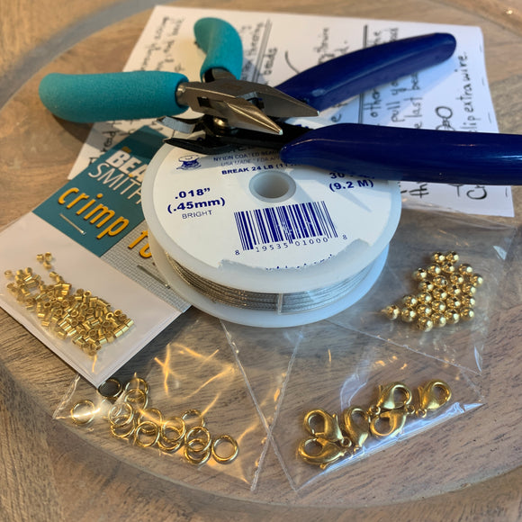 basic beading tool kit full of jewelry making supplies including chain nose pliers, soft wire cutters, beading wire, crimp beads, soldered rings, lobster claw clasps and 4mm round beads