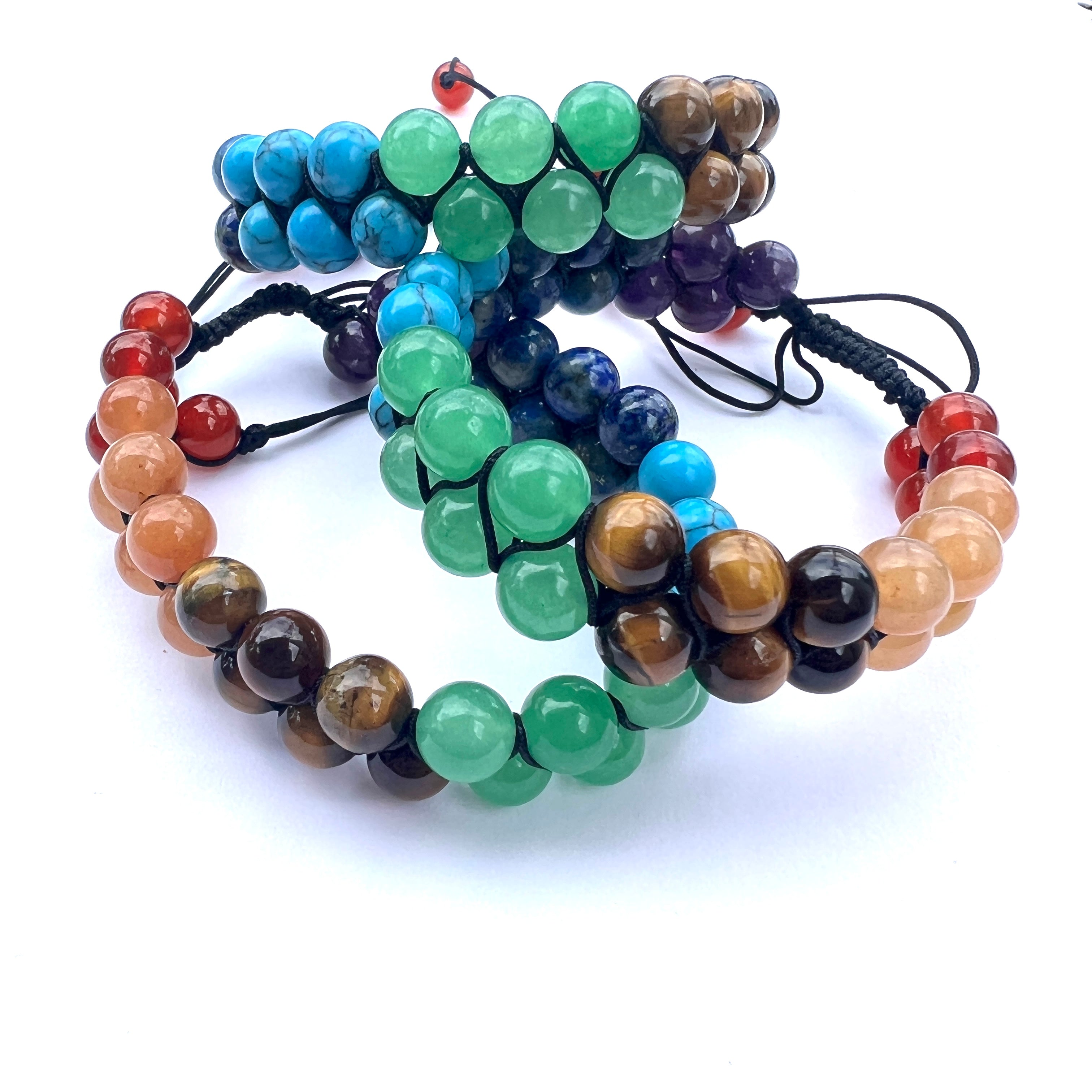 three stacked heavy nylon double row chakra beaded adjustable bracelets on white background. 