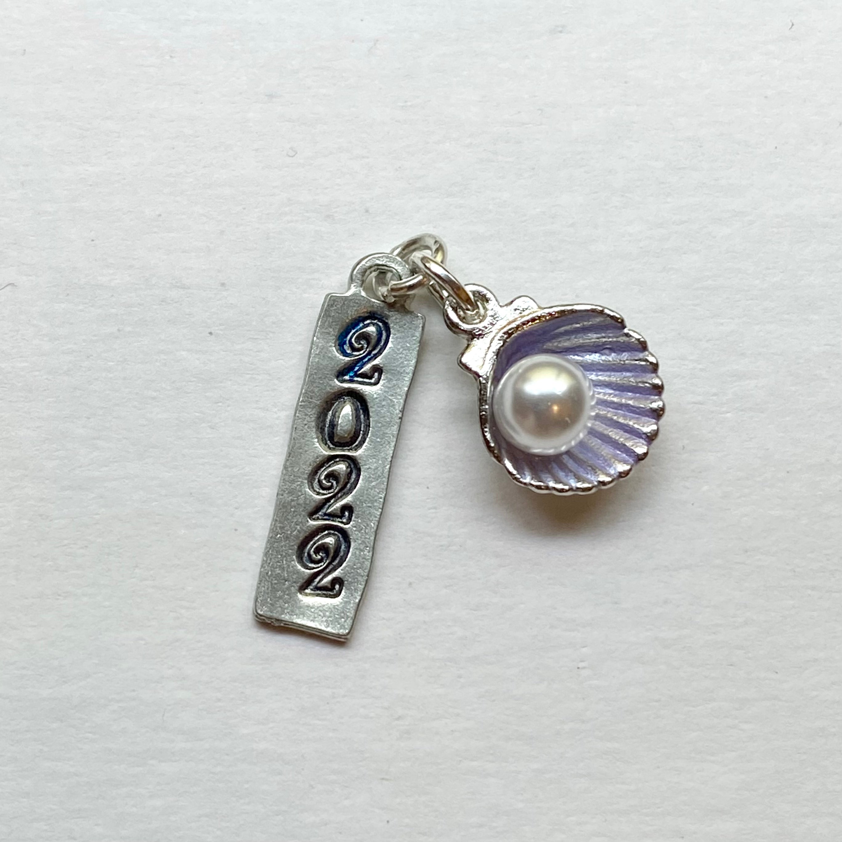 sirens krewe signature tag 2022 shell with pearl  