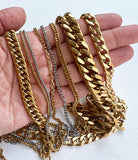 hang displaying a variety of chains including both the stainless steel and golden flat cable chains on a white background. 