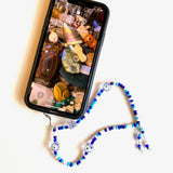 Kit includes jewelry making supplies such as glass beads and evil eye beads to make your own phone lanyard/phone holder. 