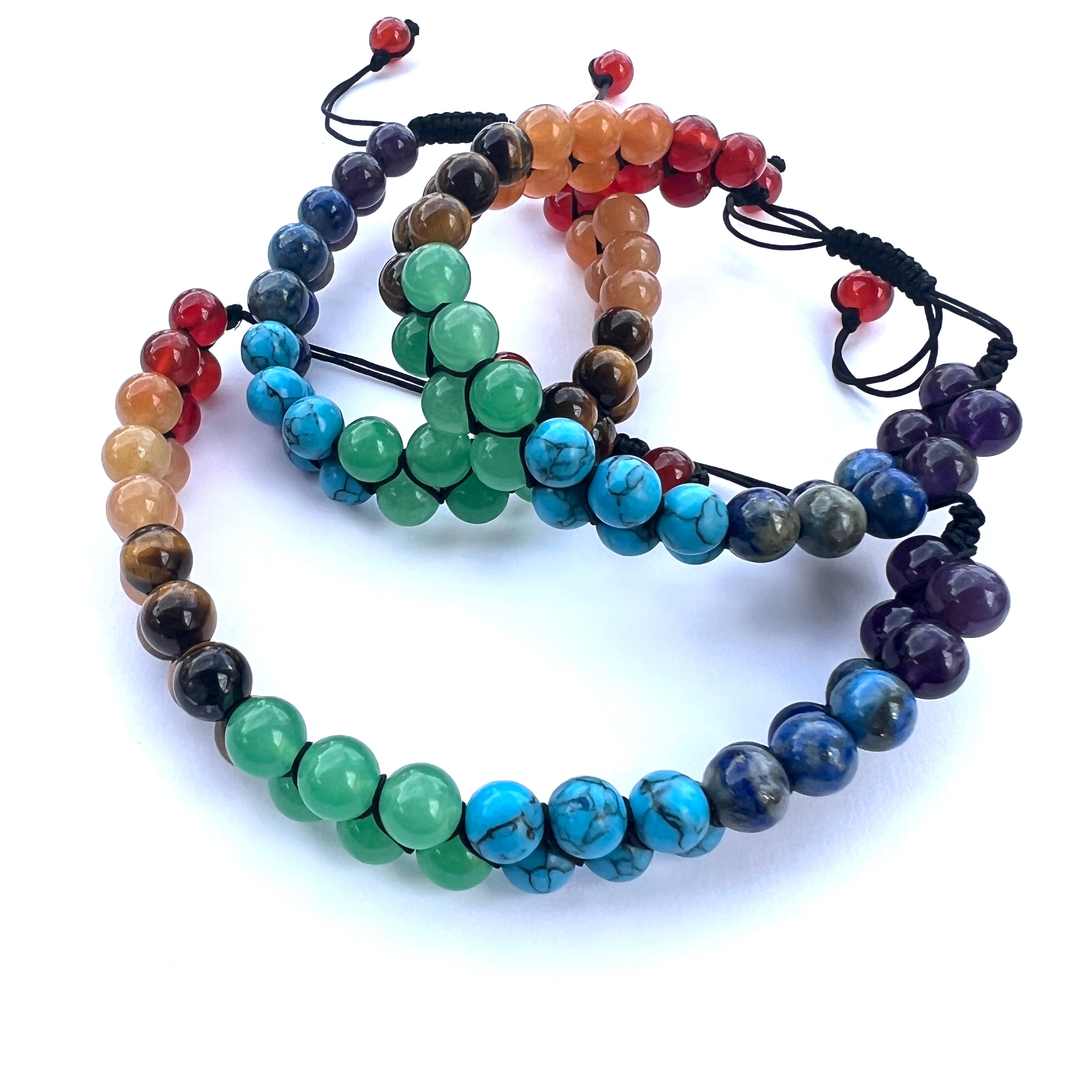three stacked heavy nylon double row chakra beaded adjustable bracelets on white background. 