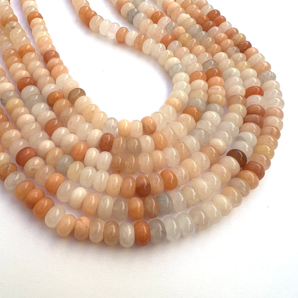 multi-colors of pink aventurine stone rondelles on strands on a white background