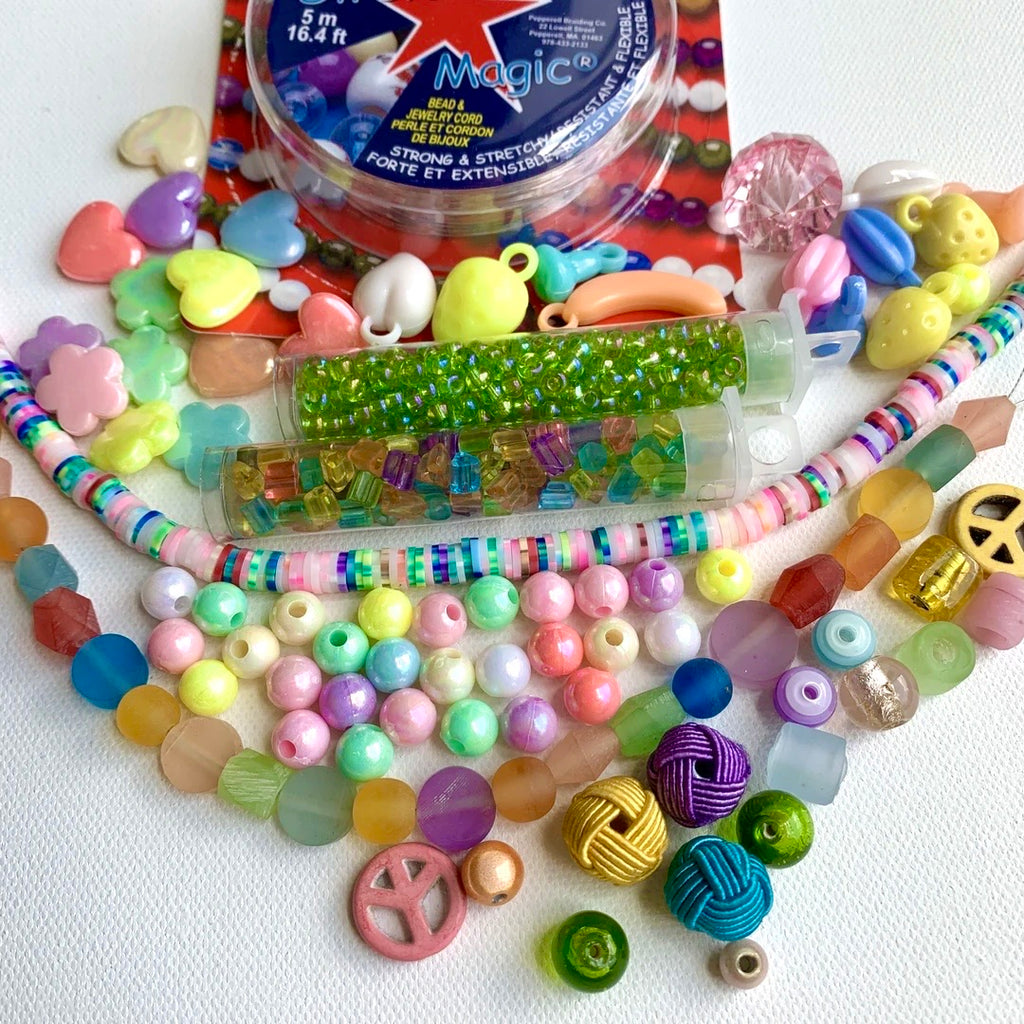 Bead kit full of jewelry making supplies perfect to make beaded bracelets. Kit includes glass beads, seed beads, heishi beads and charms