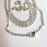 silver tone cable chain necklace with lobster claw over white background. 